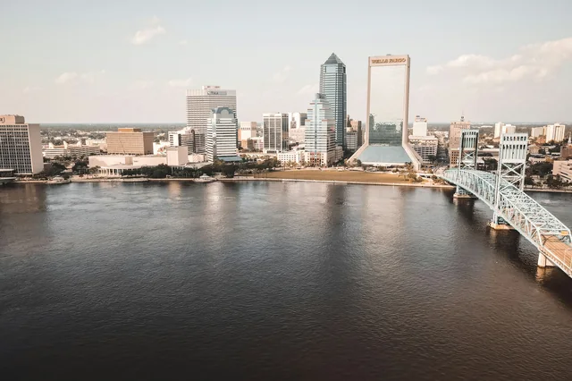 Downtown Jacksonville and the Main Street Bridge across the St. Johns River, photographed in daylight.