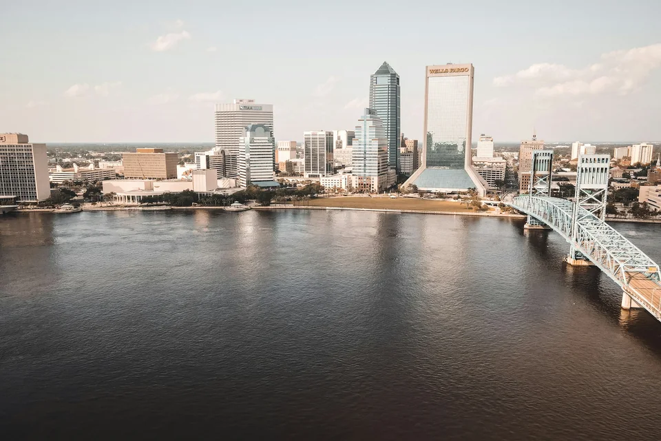 Downtown Jacksonville and the Main Street Bridge across the St. Johns River, photographed in daylight.