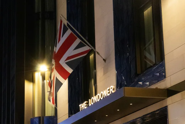 The Londoner hotel frontage and entrance canopy at night.